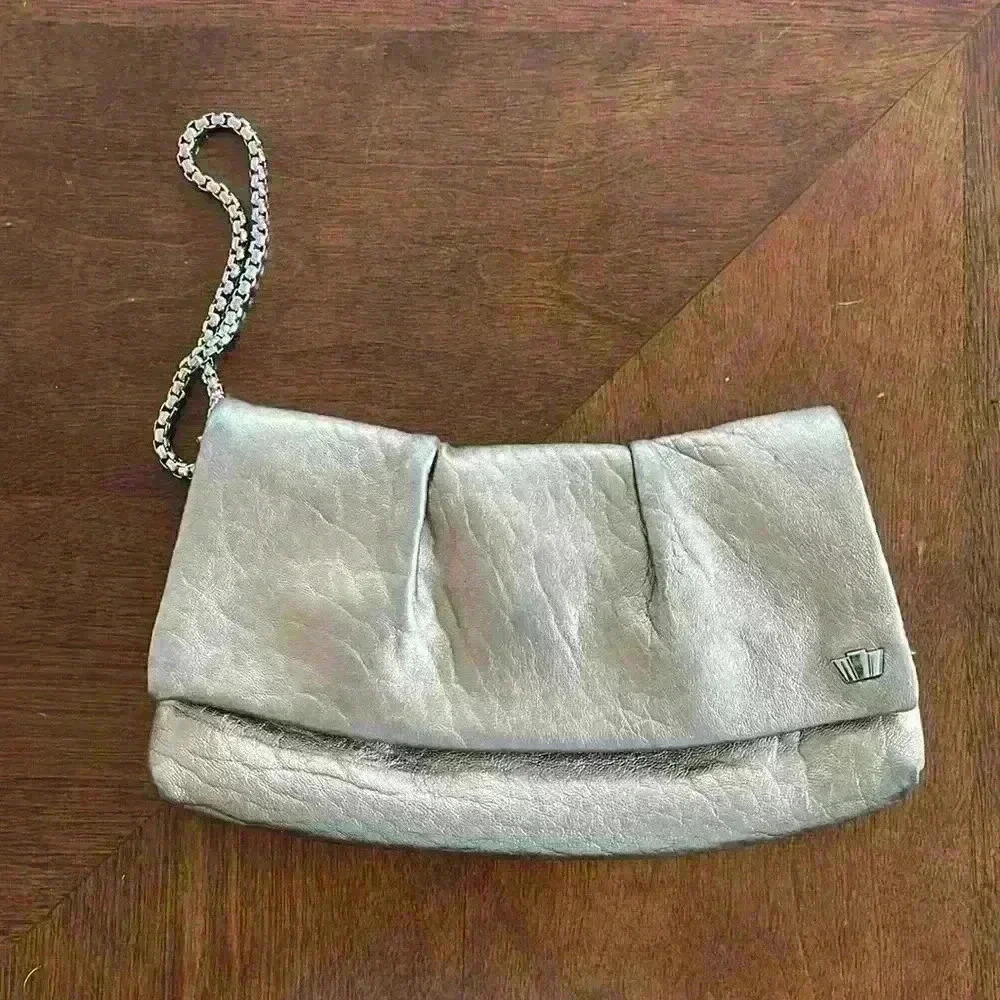 Beautiful Henri Bendel bronze wristlet with purple interior